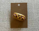 Handmade hot dog polymer clay brooch pin paper background