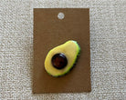 Avocado handmade polymer clay brooch pin with paper background