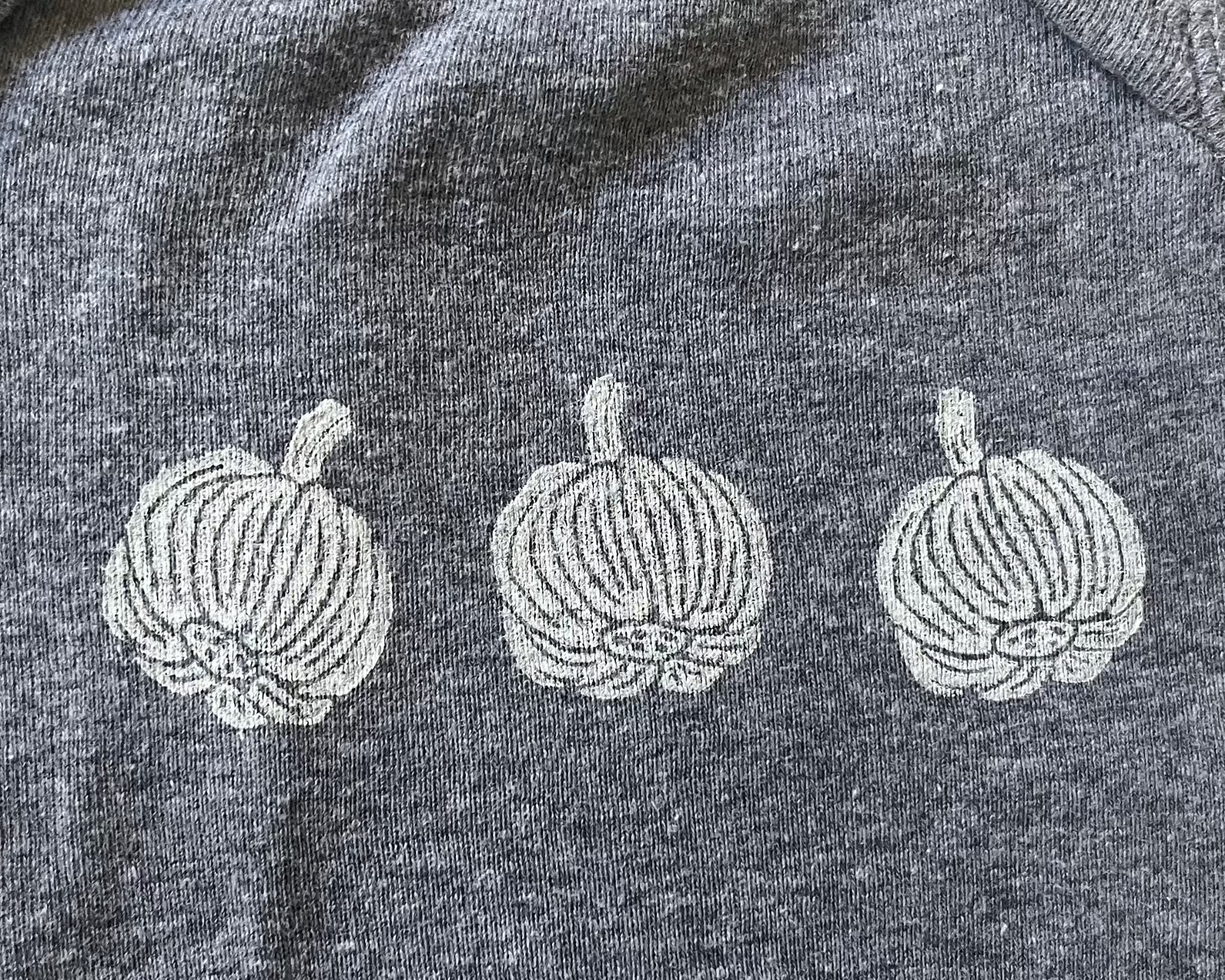 hand printed garlic block print baby onesie close up