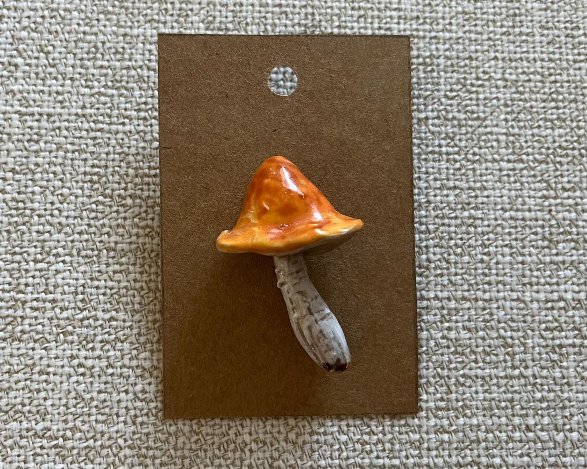 handmade mushroom polymer clay brooch pin paper background