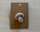 handmade mushroom polymer clay brooch pin paper background