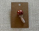 Handmade mushroom polymer clay brooch pin paper background