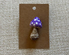 Handmade mushroom polymer clay brooch pin paper background