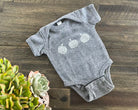 Hand printed garlic block print baby onesie